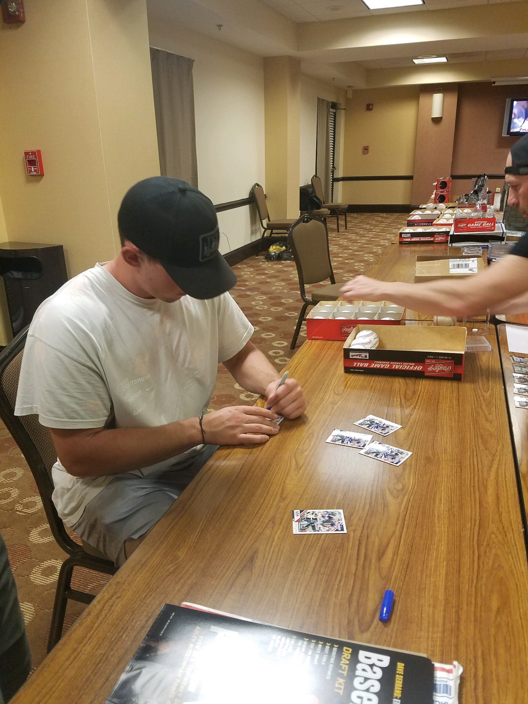 Adley Rutschman autographing USA Baseball cards 2